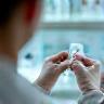 Quality control specialist examining a cosmetic sample
